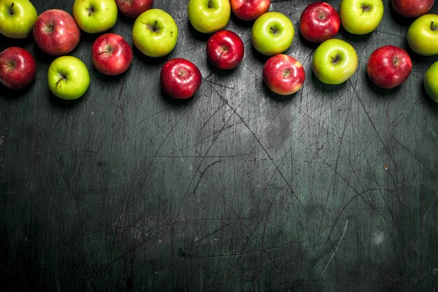 Red and green apples. on a rustic background.