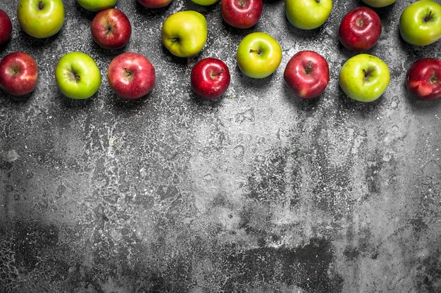 Red and green apples. On a rustic table.