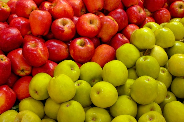 Red and green apples on the shop counter.