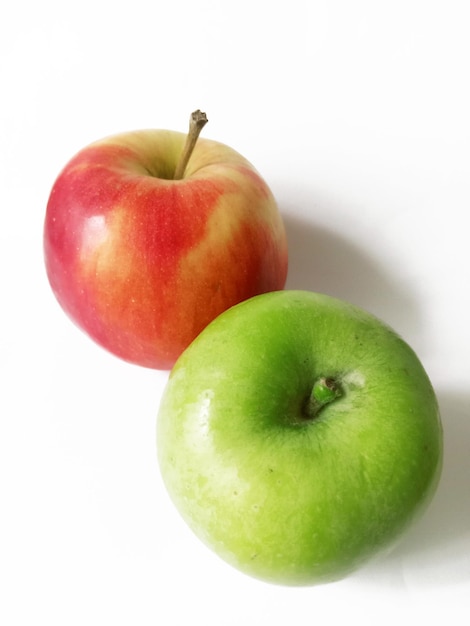 red and green apples on white background