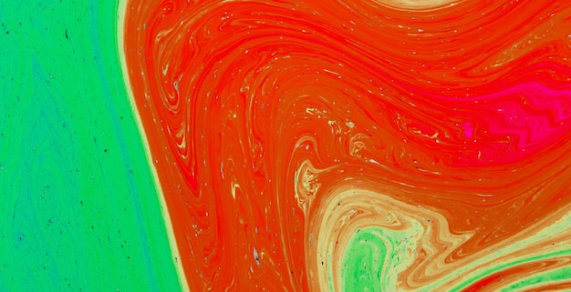 A red and green background with a swirly pattern.