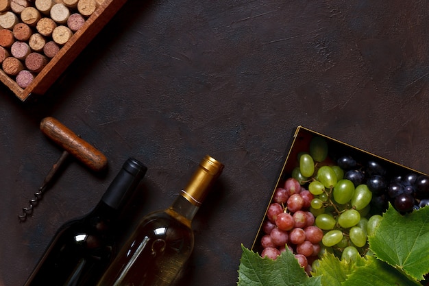 Red, green and  blue grapes with leaves in metal box