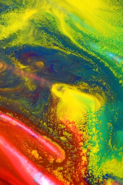 Red, green, blue, yellow colors mixed fluid macro