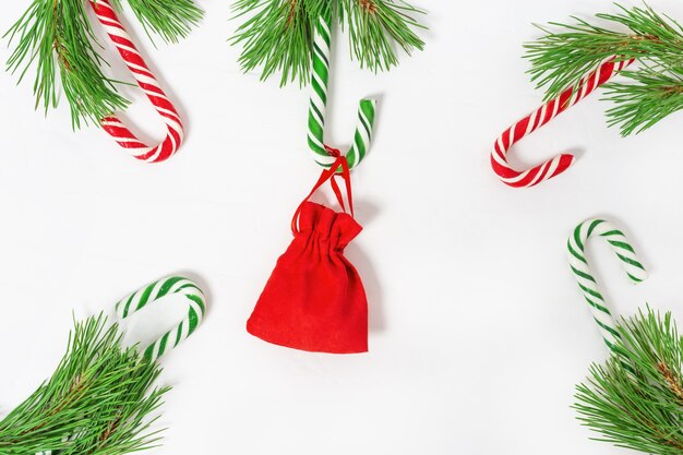 Red and green candy canes with small gift, Christmas theme.