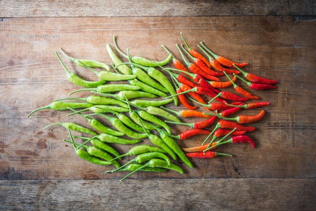 Red and green chili pepper on an old wooden background