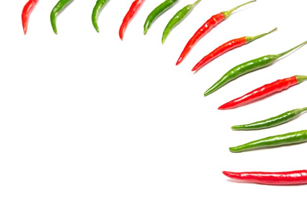 Red and green chili peppers on white background. Selective focus, copy space