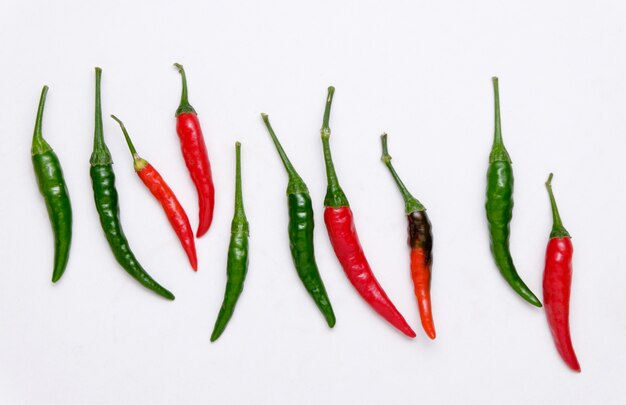 Red and green chili on white background