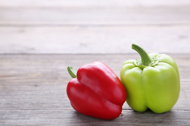 Red and green pepper on a grey background