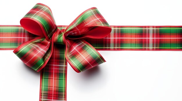 Photo red and green plaid ribbon tied in a bow on a solid white background