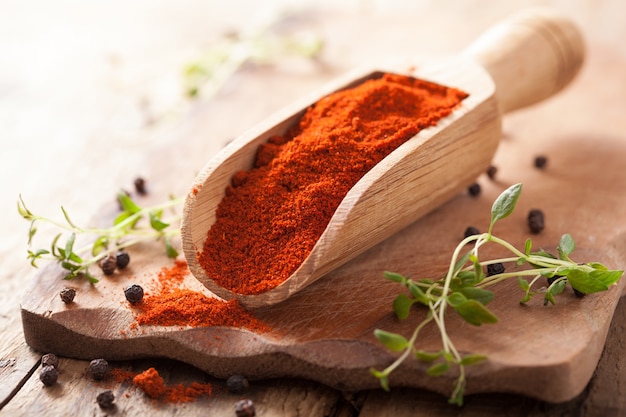 Red ground paprika spice in wooden scoop