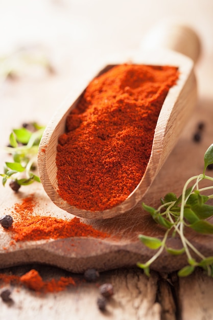 Red ground paprika spice in wooden scoop