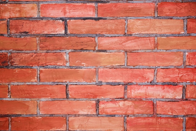 Red grunge brick in the wall with gray putty