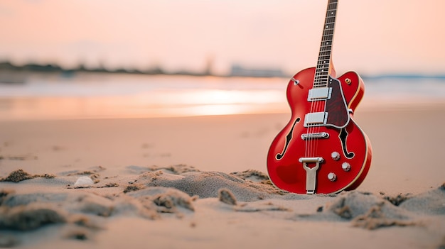 A red guitar sits in the sand on a beach.