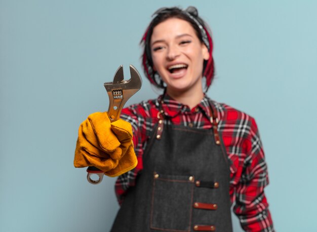 Red hair cool handywoman holding tool