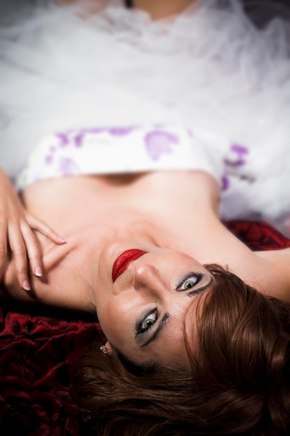 Red Hair. Fashion Girl Portrait. young woman lying on sofa, shallow depth of field