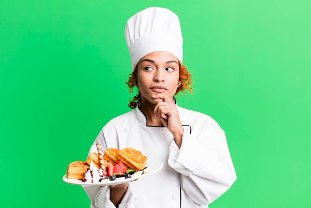 Photo red hair pretty chef woman cooking waffles