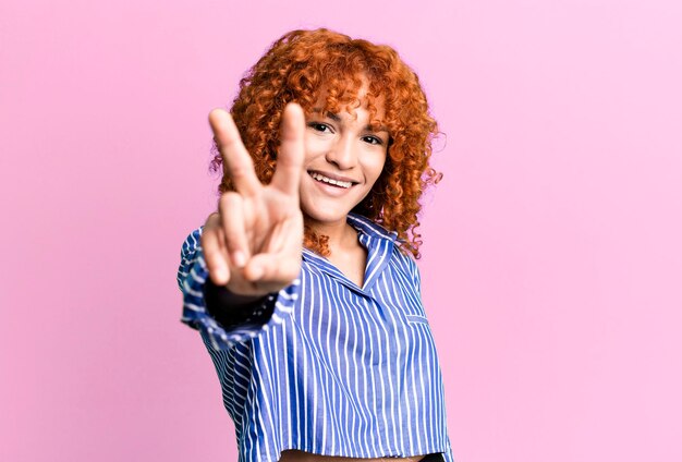 Red hair pretty woman against isolated background