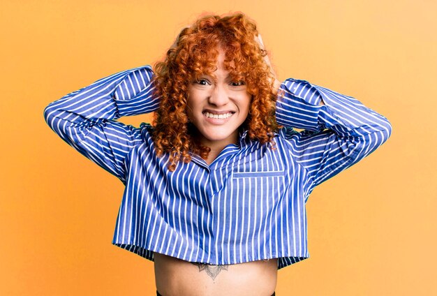 Red hair pretty woman against isolated background