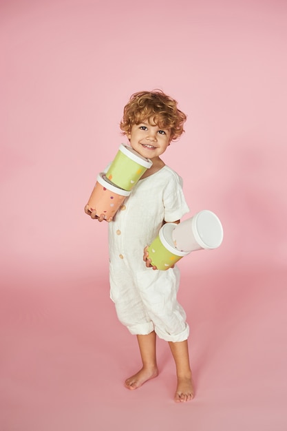 Red-haired boy with colored paper boxes.