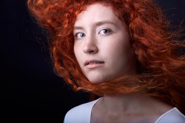 Red haired girl on black backdrop