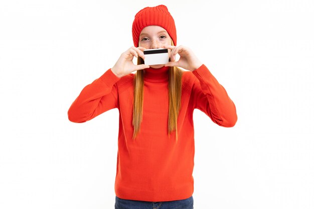 Red-haired girl holding a credit card