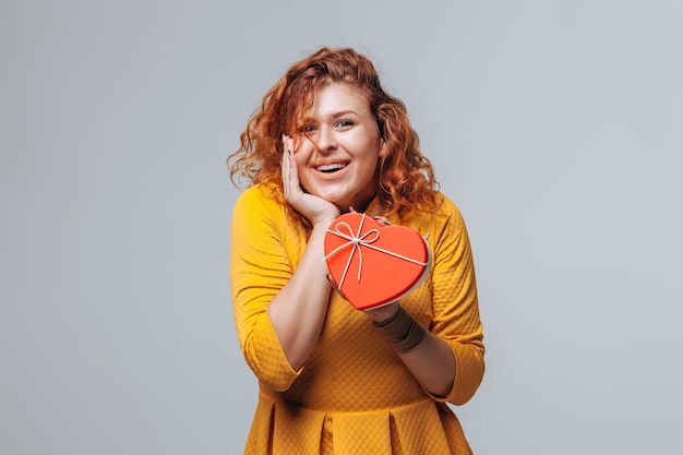 Red-haired girl received a gift box heart