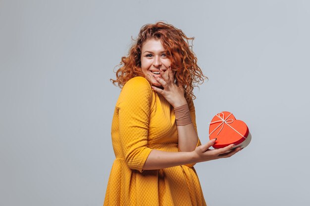 Red-haired girl received a gift box heart