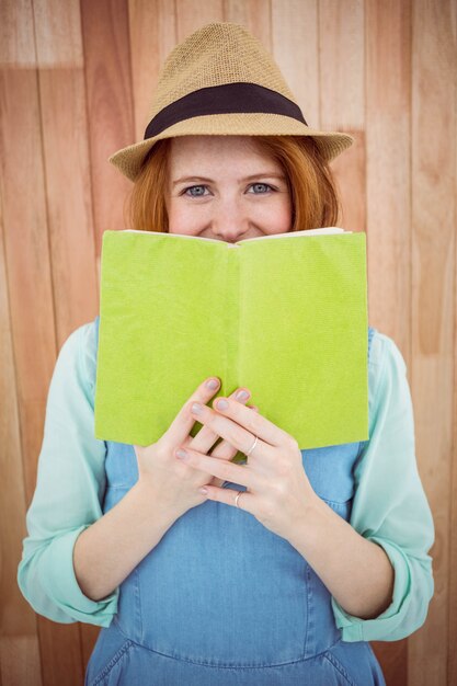 Red haired hipster reading a book