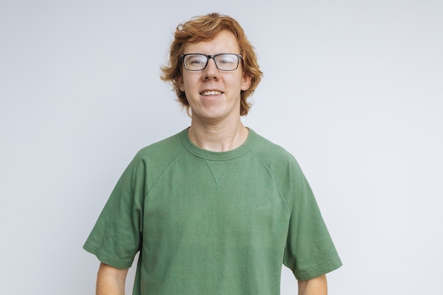 Red-haired man in glasses and a green T-shirt