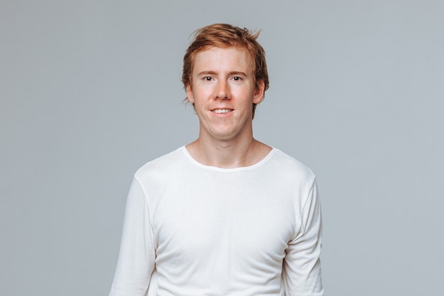 red haired man on a light background portrait