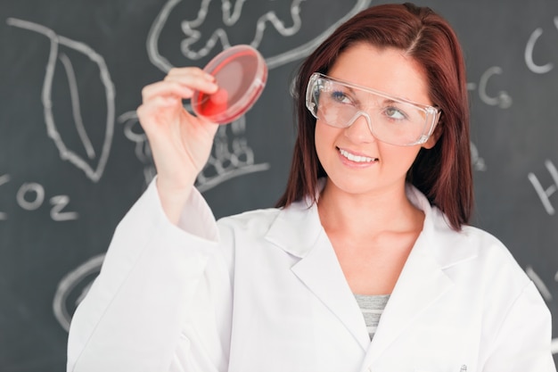 Red-haired scientist holding a petri dish