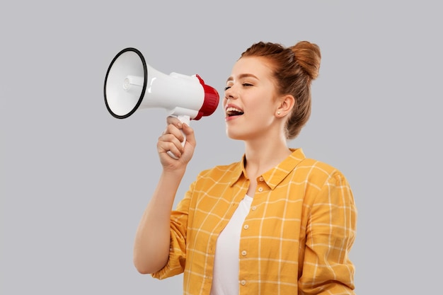 red haired teenage girl speaking to megaphone