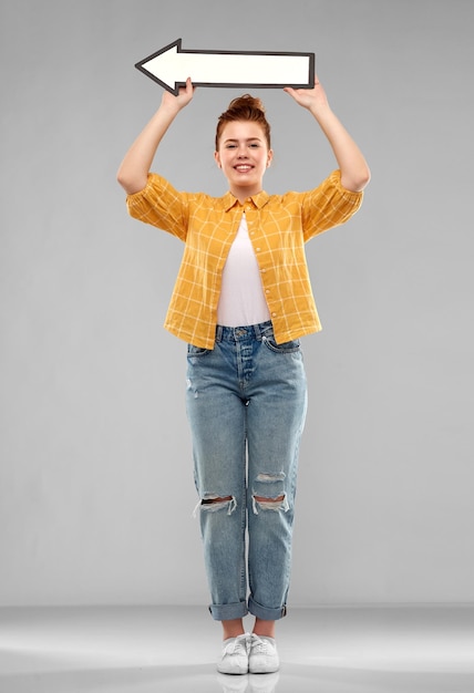 red haired teenage girl with arrow showing to left