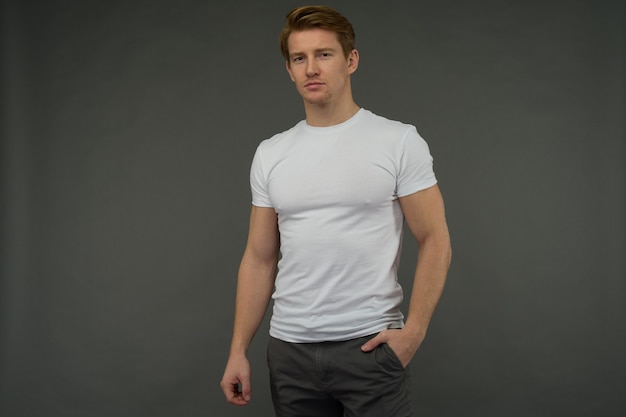 Red-haired young man posing isolated