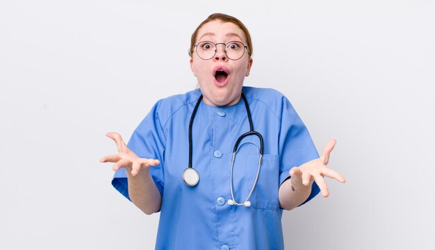 red head pretty woman feeling extremely shocked and surprised nurse concept