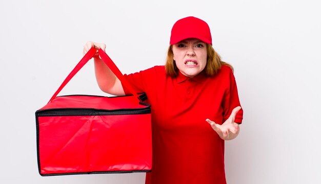 Red head pretty woman looking angry annoyed and frustrated pizza delivery concept