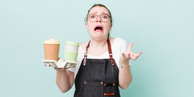 Red head pretty woman looking desperate frustrated and stressed take away coffee concept