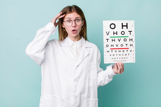 Red head pretty woman looking happy astonished and surprised optical vision test concept