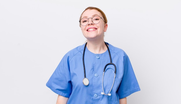 Red head pretty woman looking happy and pleasantly surprised nurse concept