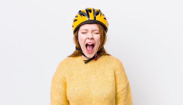 Red head pretty woman shouting aggressively looking very angry cycling concept