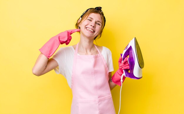 Red head pretty woman smiling confidently pointing to own broad smile housekeeper concept