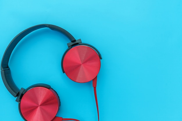 Red headphones on turquoise blue background