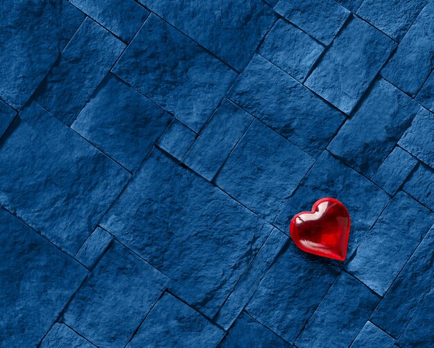 A red heart against a solid blue stone.