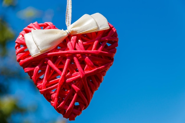 Red heart on the background of blue sky