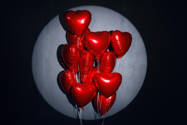 Red heart balloons on dark background