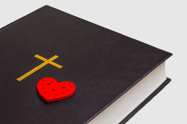 Red heart in the Bible on white