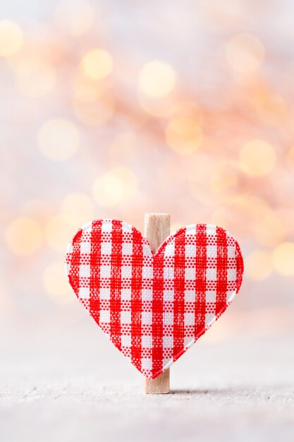 Red heart in bokeh lights background.