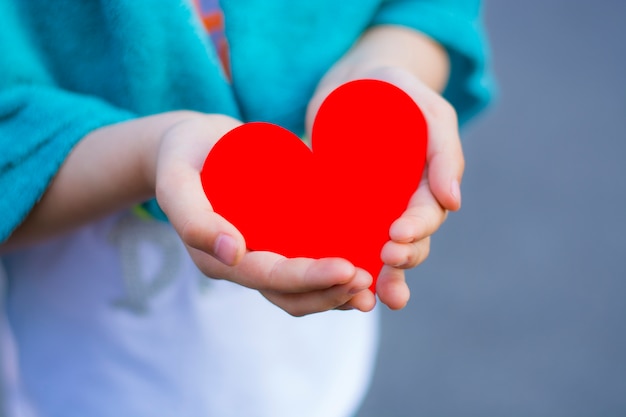 Red heart in child's hand