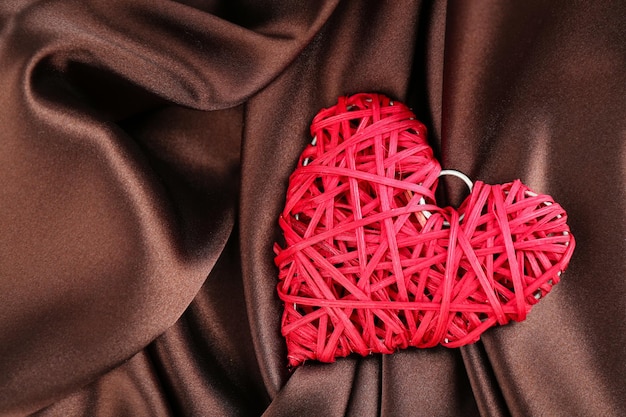 Red heart on fabric background