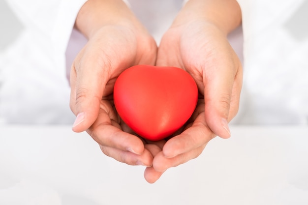 Red heart in hand healthcare concept for World Health Day or Valentine day.